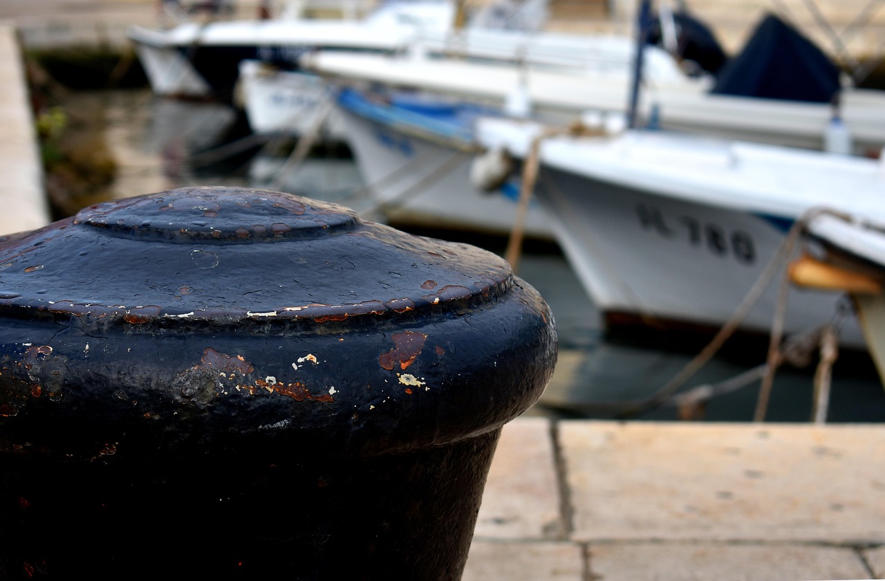 Weathered mooring bollard at a working quayside